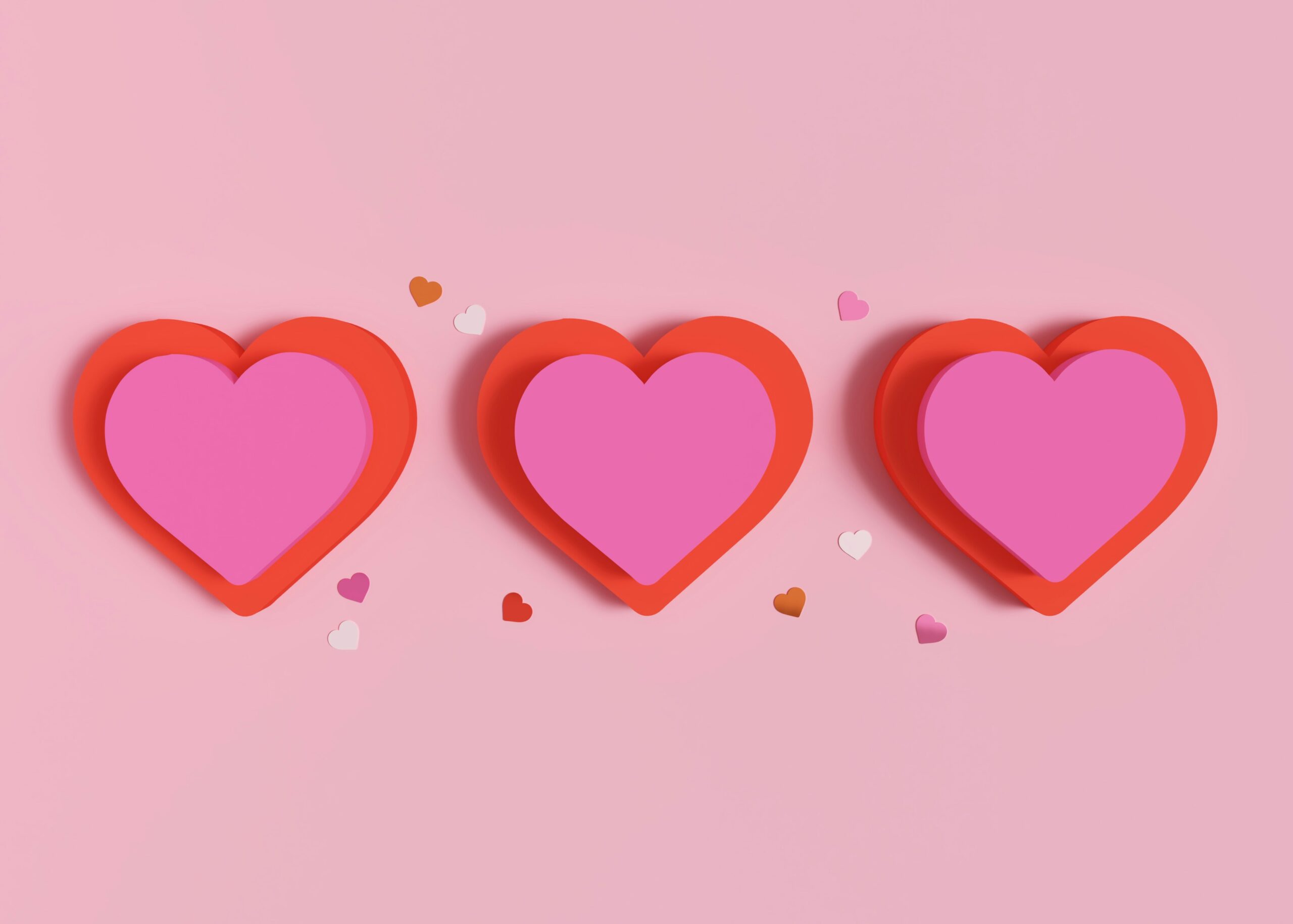 three paper red and pink hearts