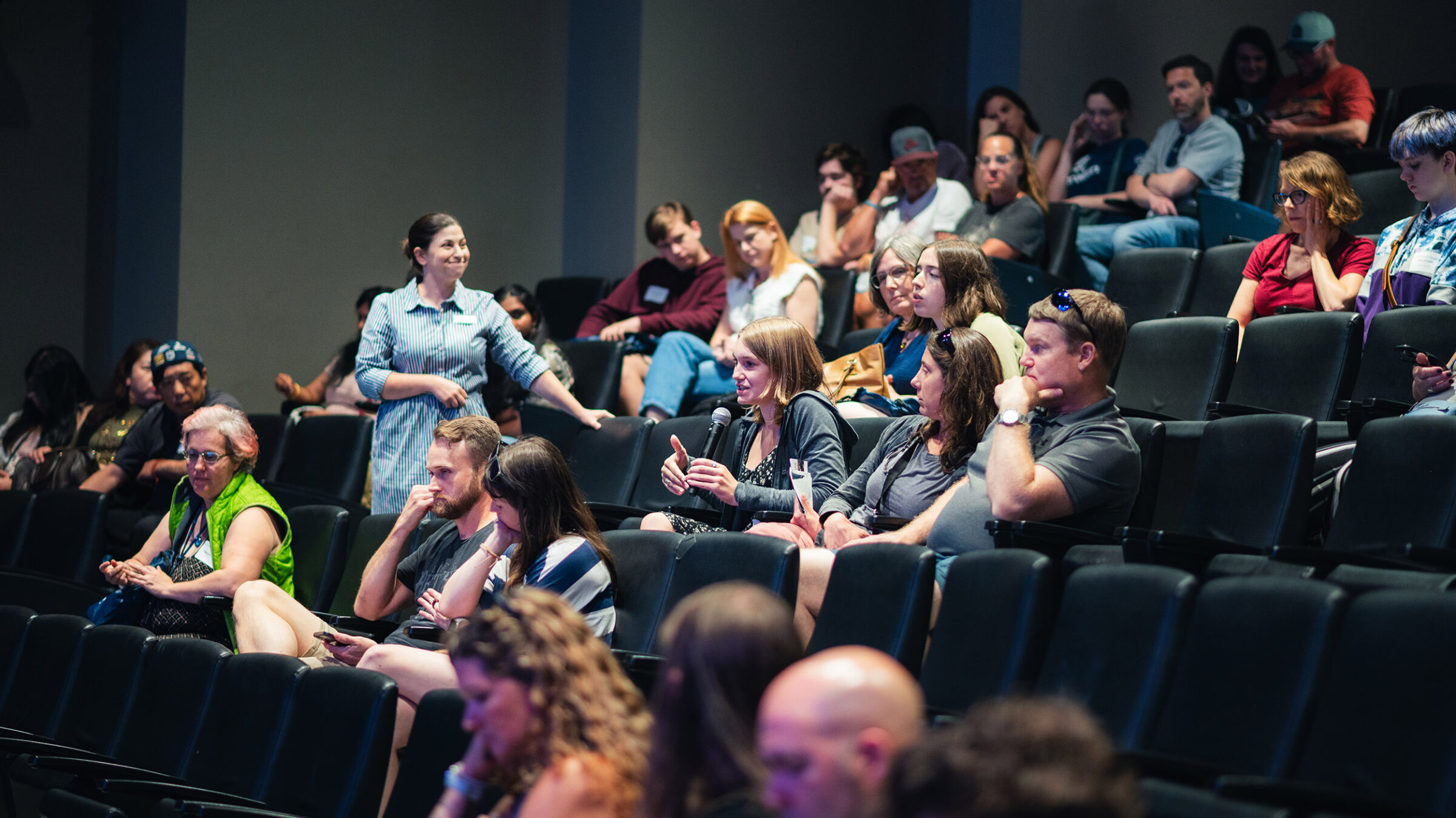 families at summer open house ask questions of admissions staff at an information session