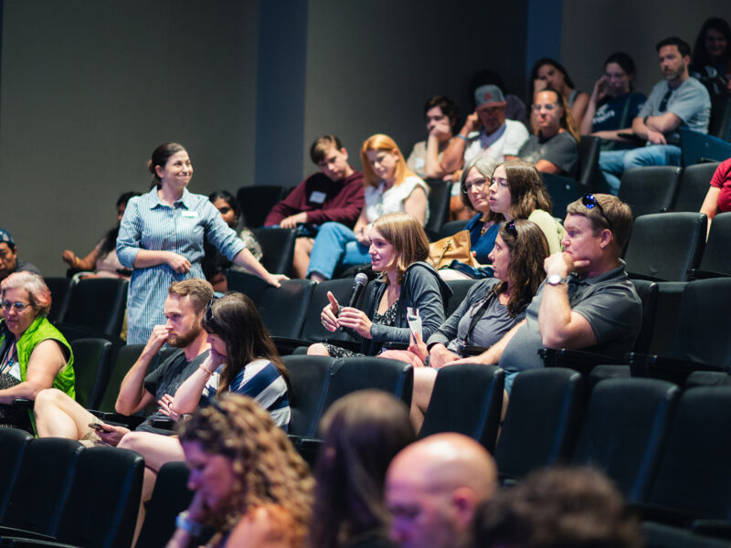 families at summer open house ask questions of admissions staff at an information session