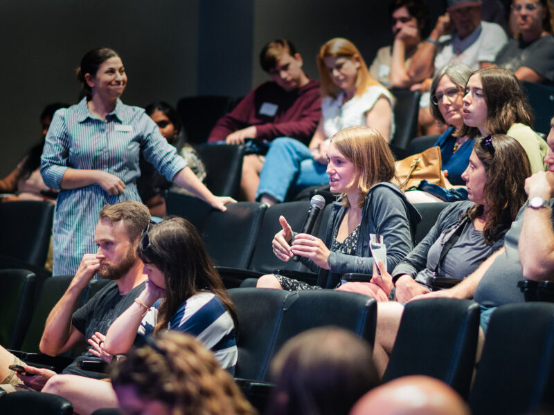 families at summer open house ask questions of admissions staff at an information session