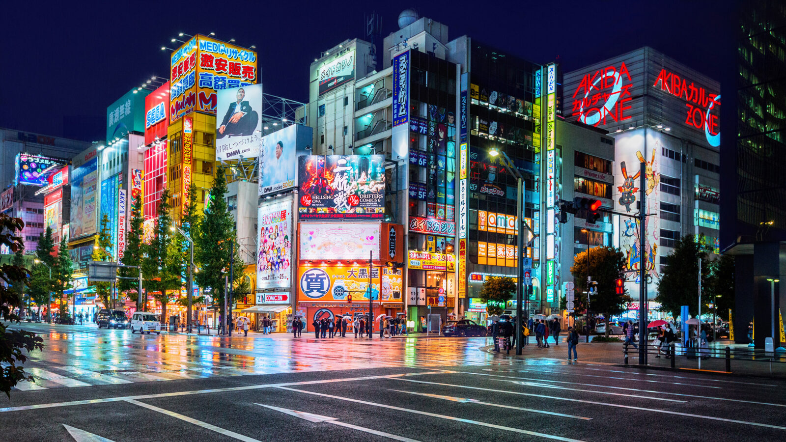 Neon lights and billboard advertisements on buildings at Akihabara at rainy night, Tokyo, Japan