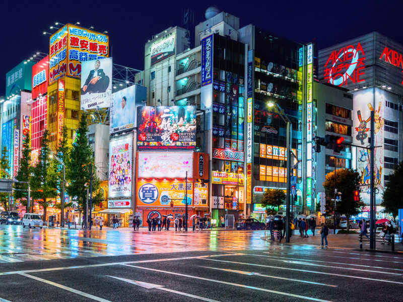 Neon lights and billboard advertisements on buildings at Akihabara at rainy night, Tokyo, Japan