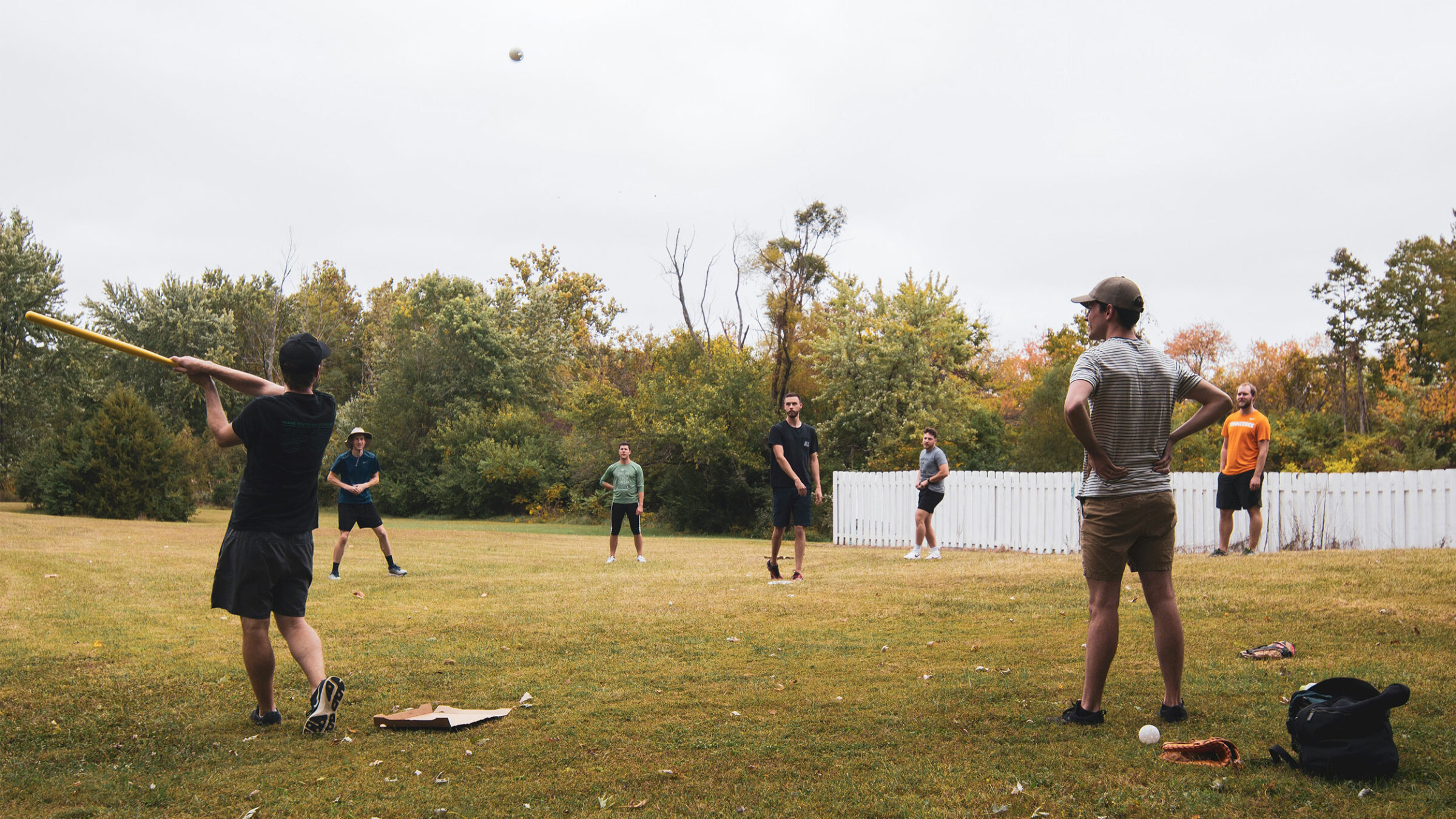 people playing wiffleball outside