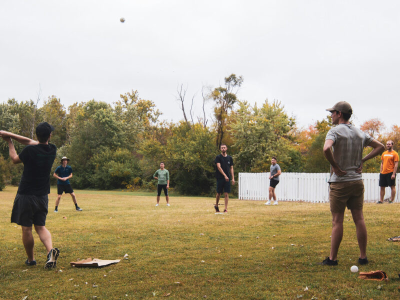 people playing wiffleball outside