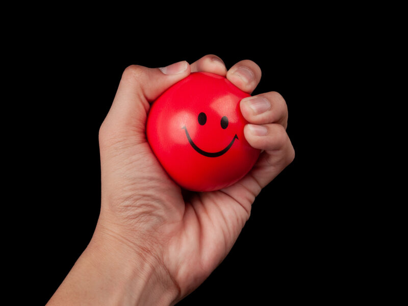 red stress ball with smiley face on it