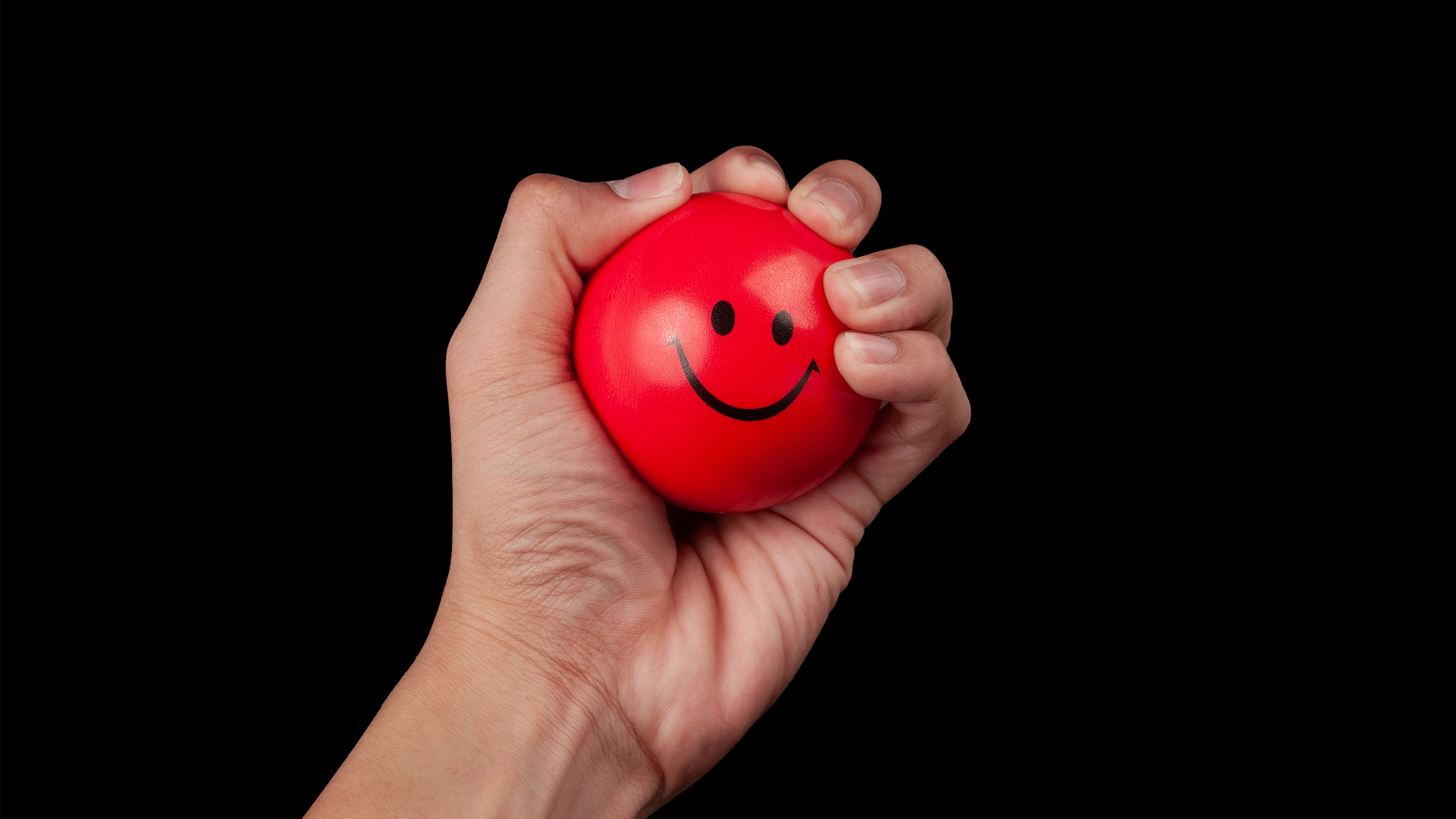red stress ball with smiley face on it