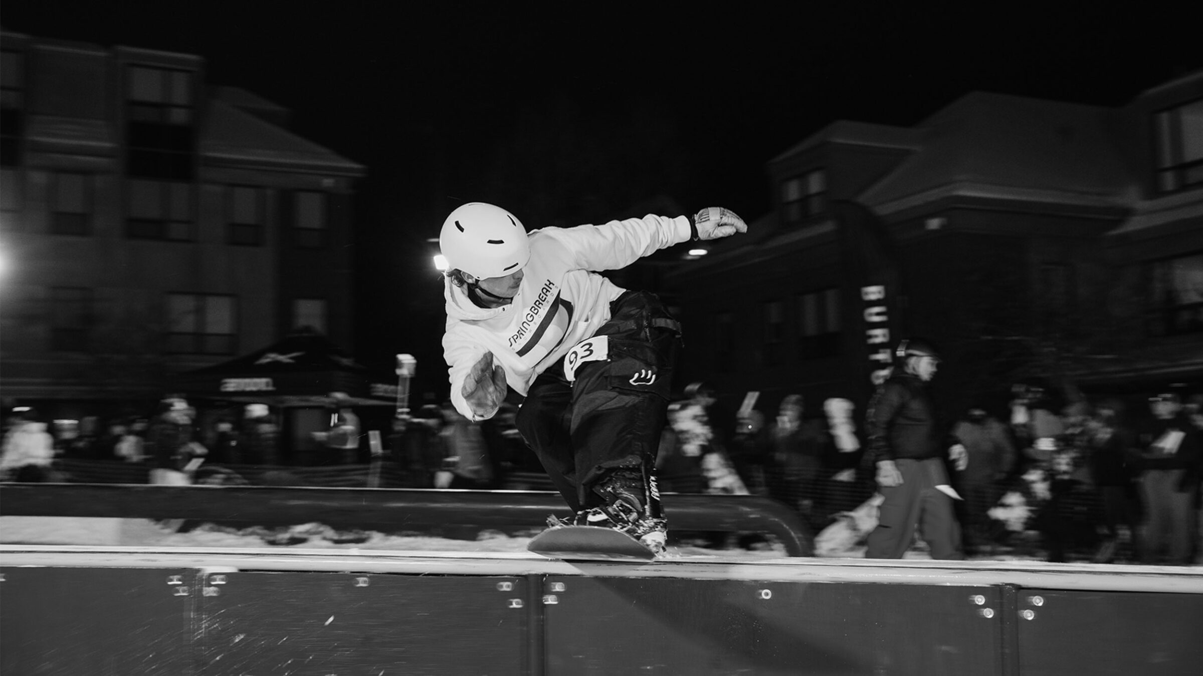 snowboarder rides a terrain rail, black and white photo