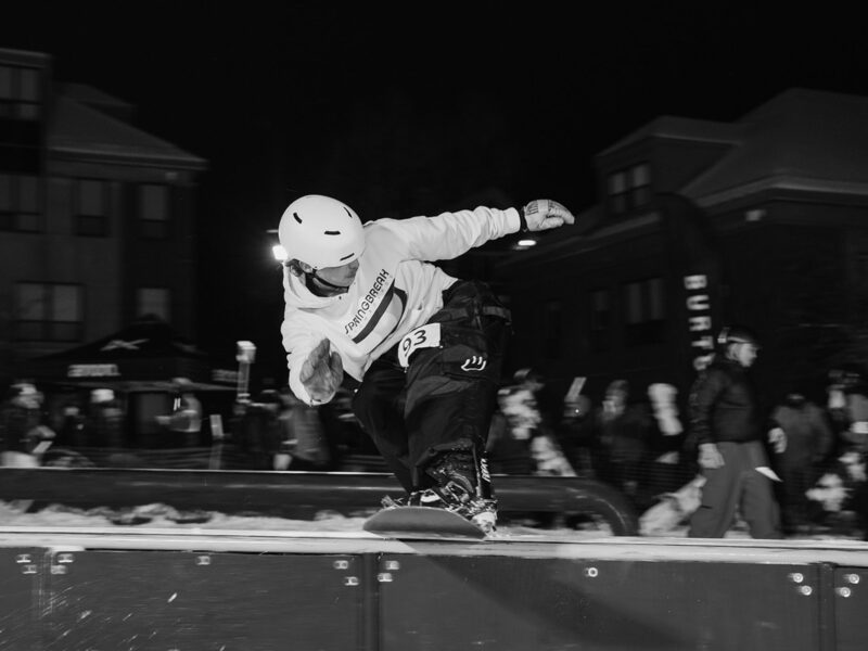 snowboarder rides a terrain rail, black and white photo