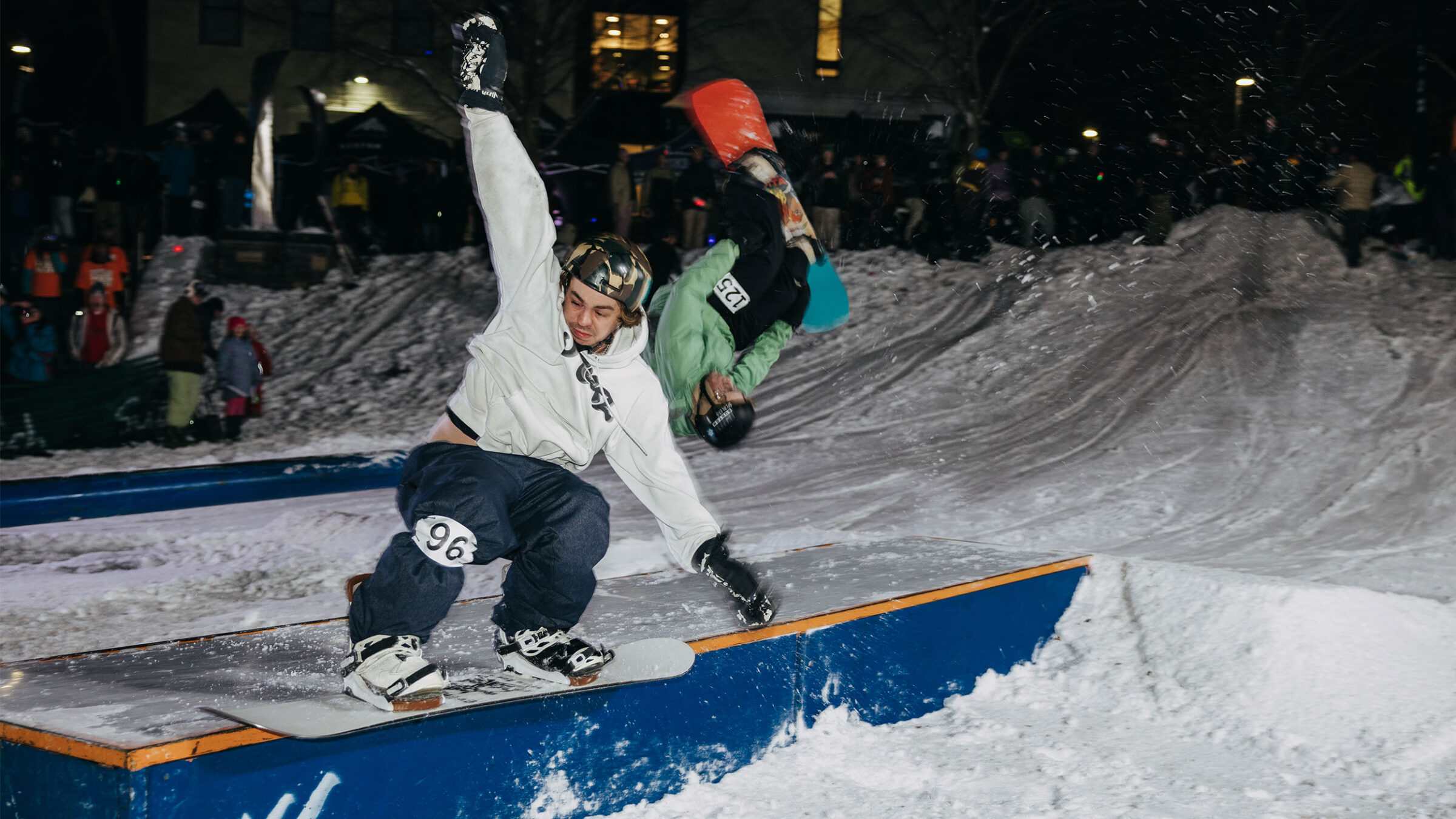 snowboarder rides a rail in the snowy finney quad