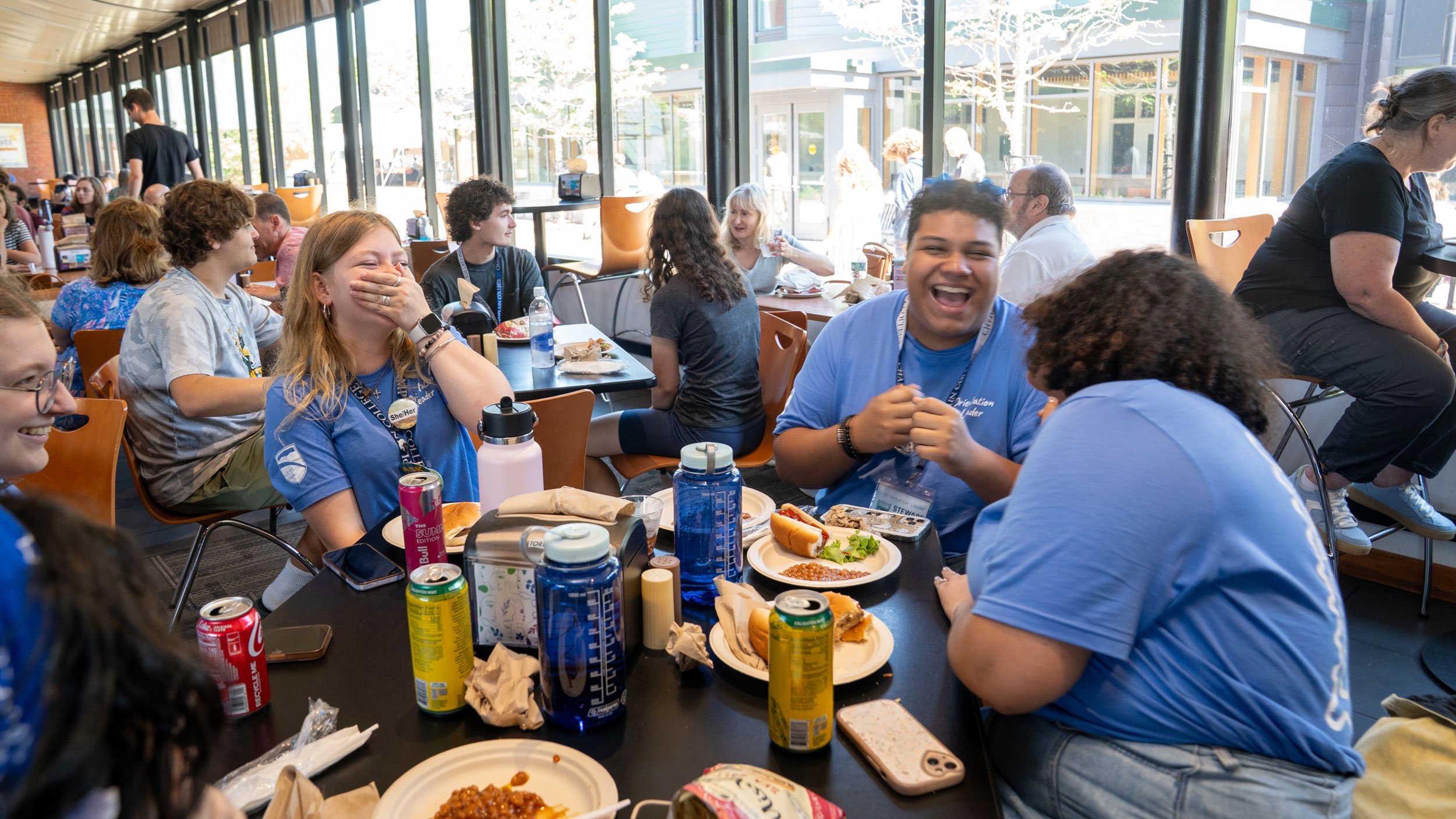 students eating and laughing in the dining hall