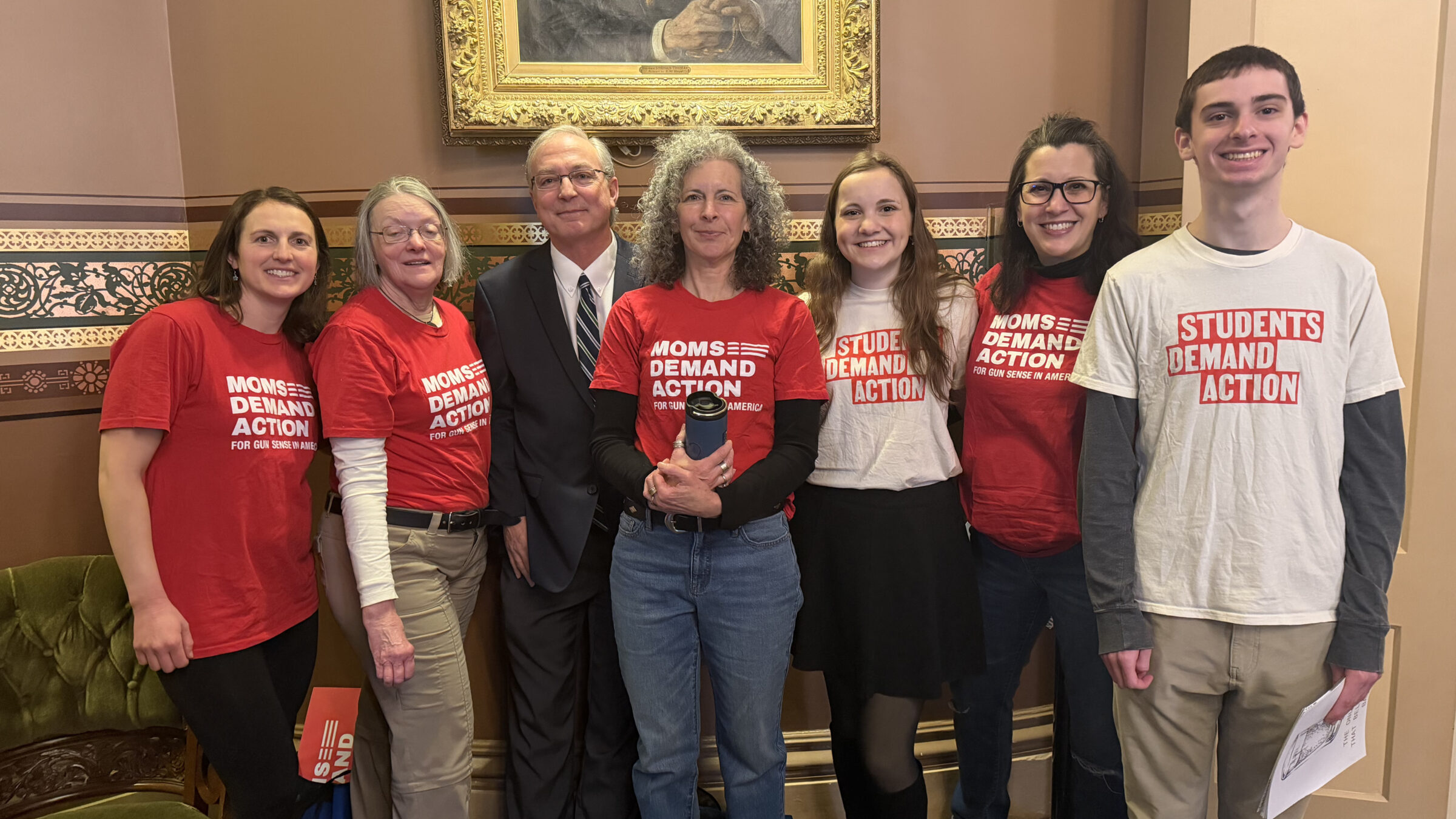 group poses smiling for a photo wearing red and white shirts