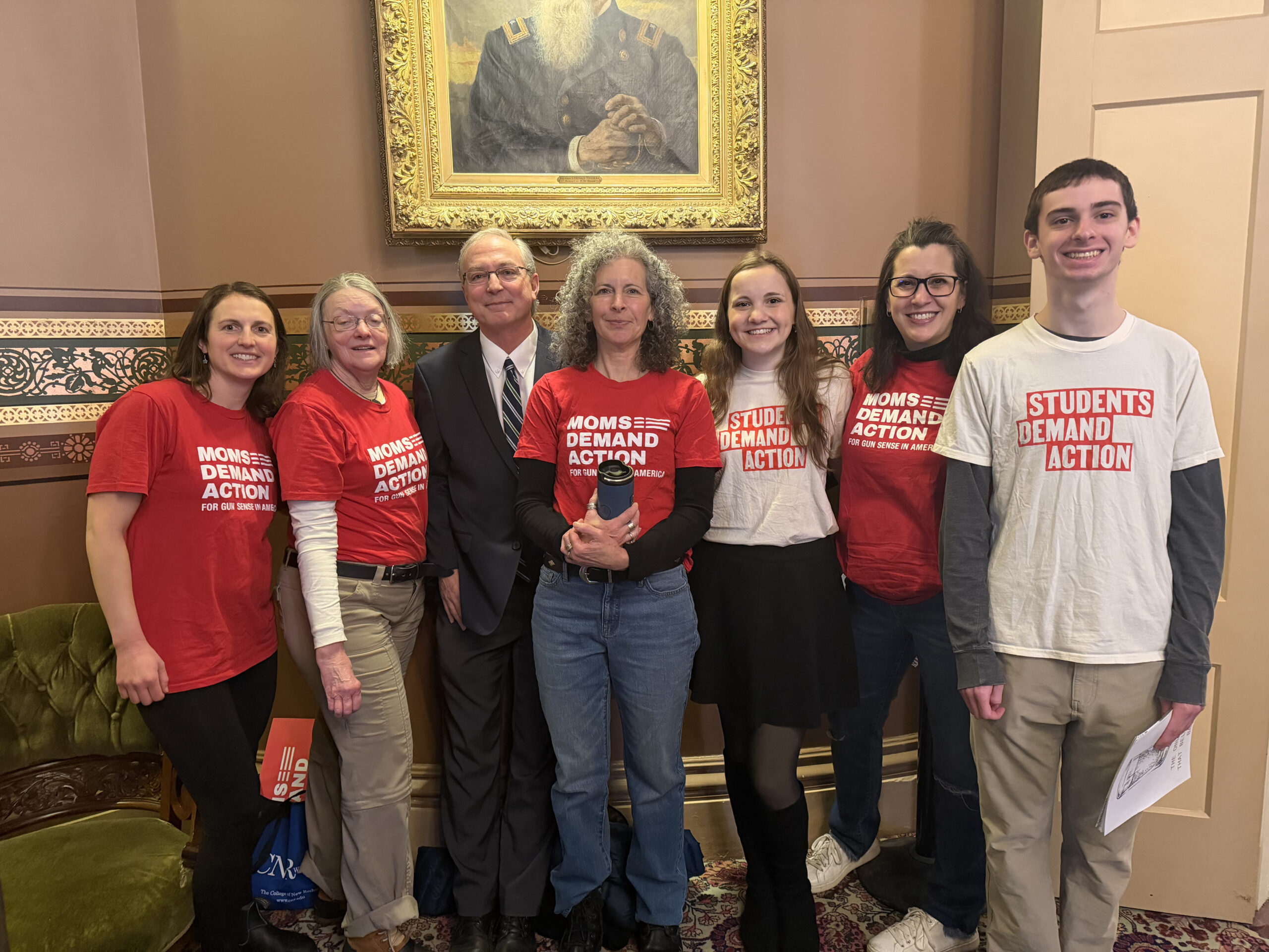 group poses smiling for a photo wearing red and white shirts