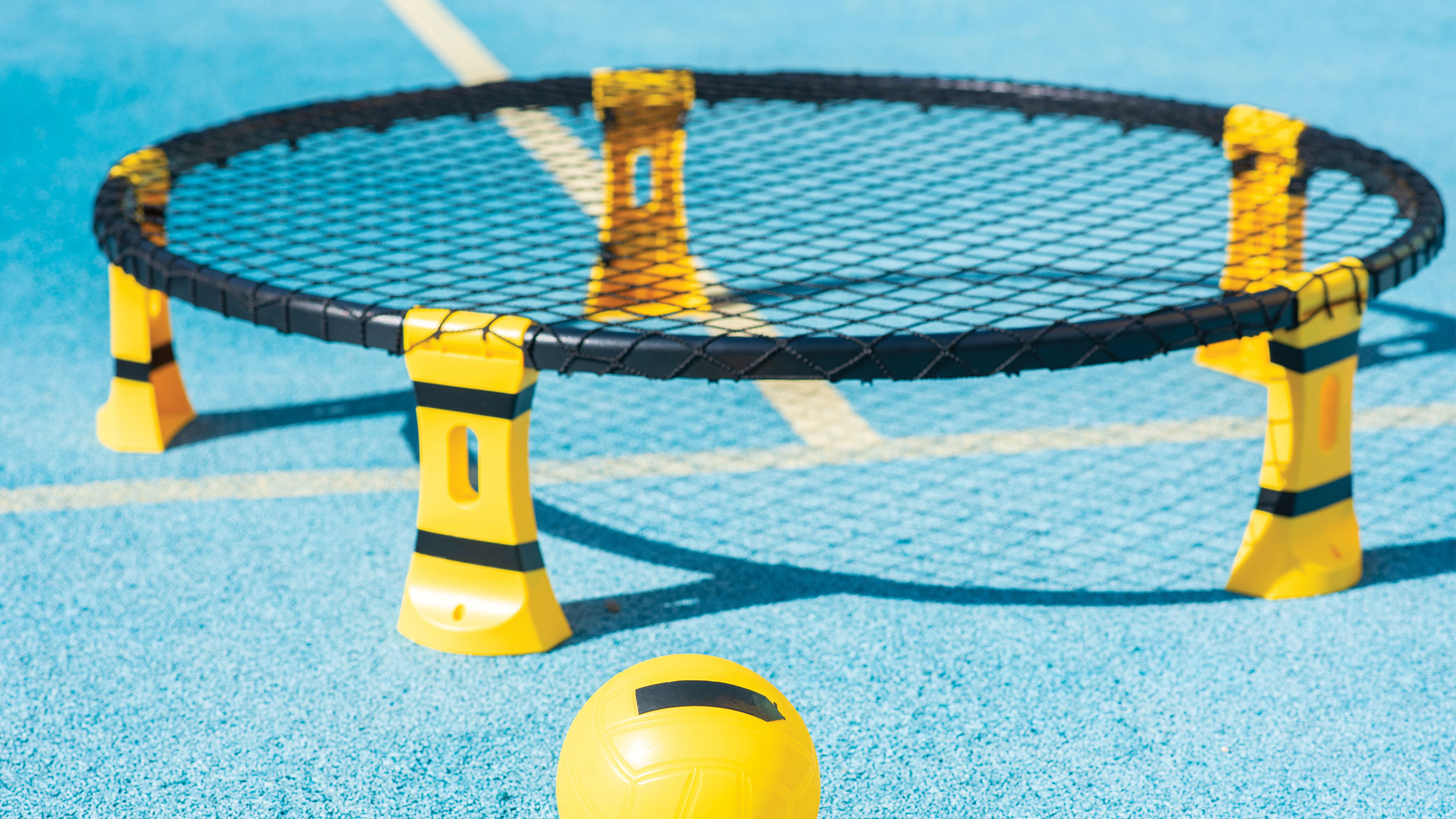 Spikeball set on blue ground.