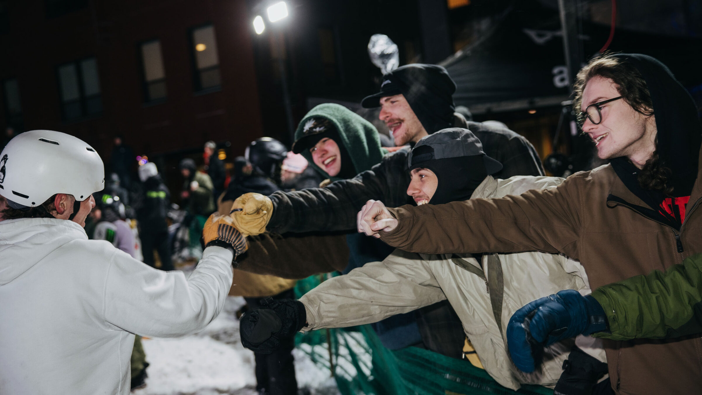 audience members at burton winter jam fist bumping a rider