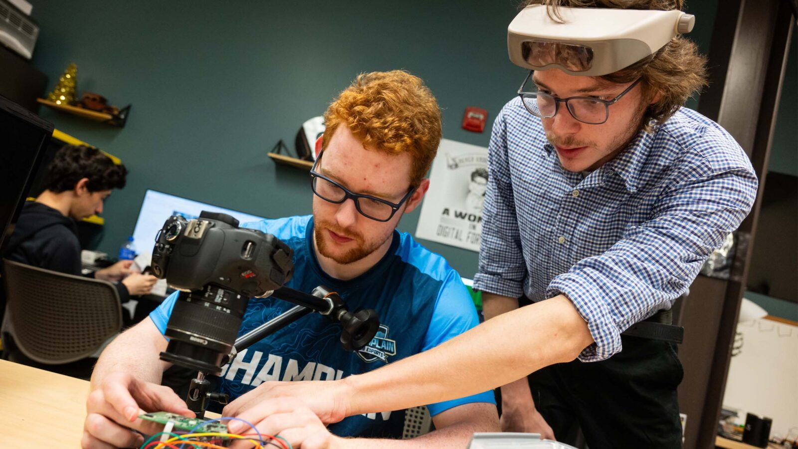 Two students working on with tech in the Leahy Center