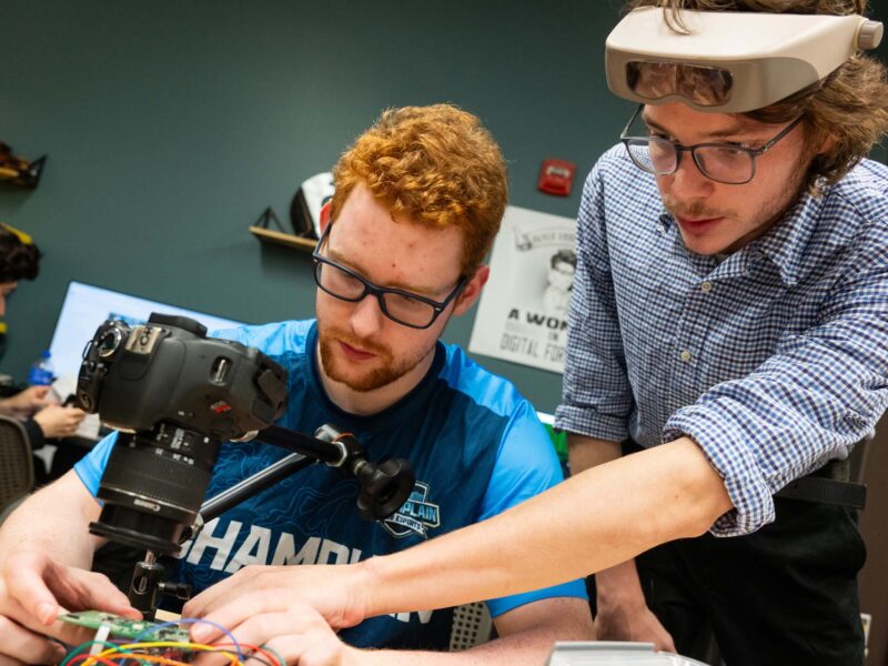 Two students working on with tech in the Leahy Center