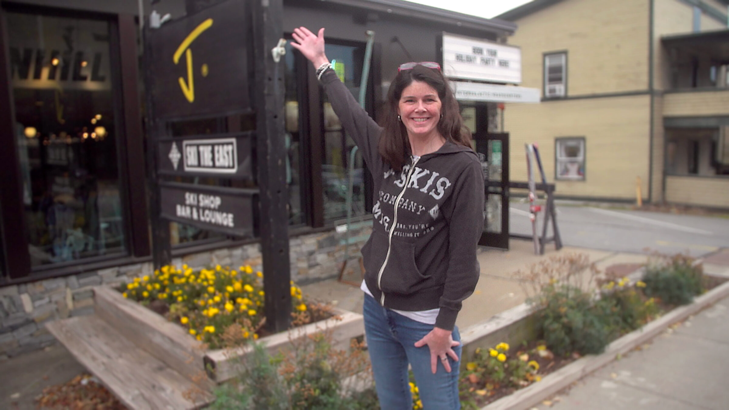 Corrine in front of the J skis and Ski The East Intergalactic Headquarters