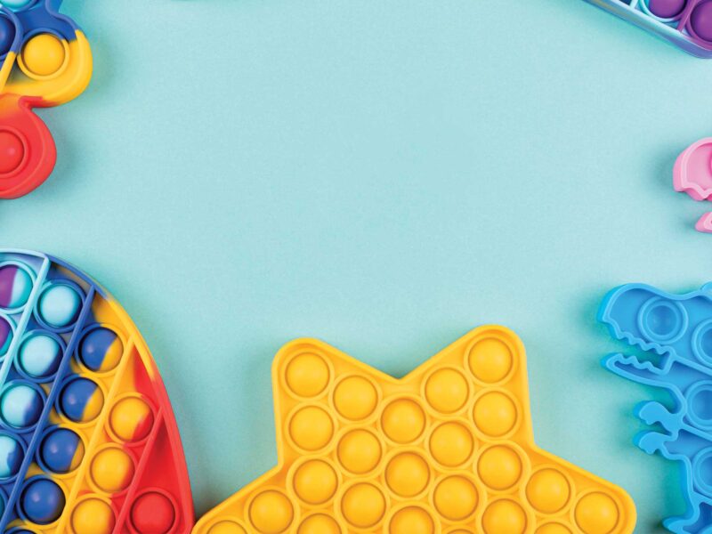 colorful fidget toys on a blue background