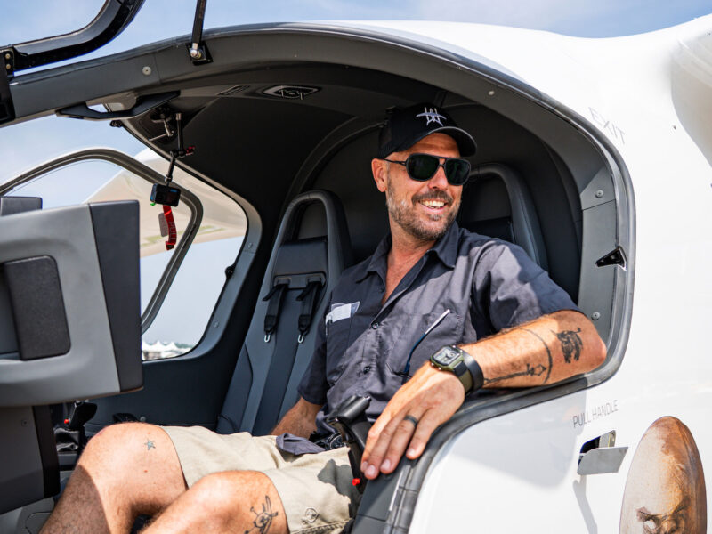 kyle clark sits in a beta aircraft smiling