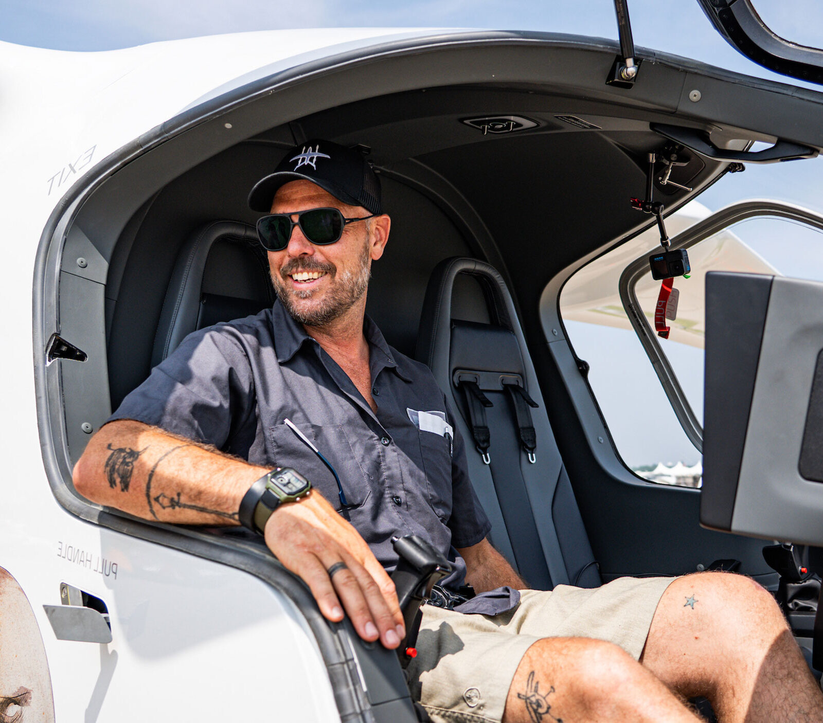 kyle clark sits in a beta aircraft smiling