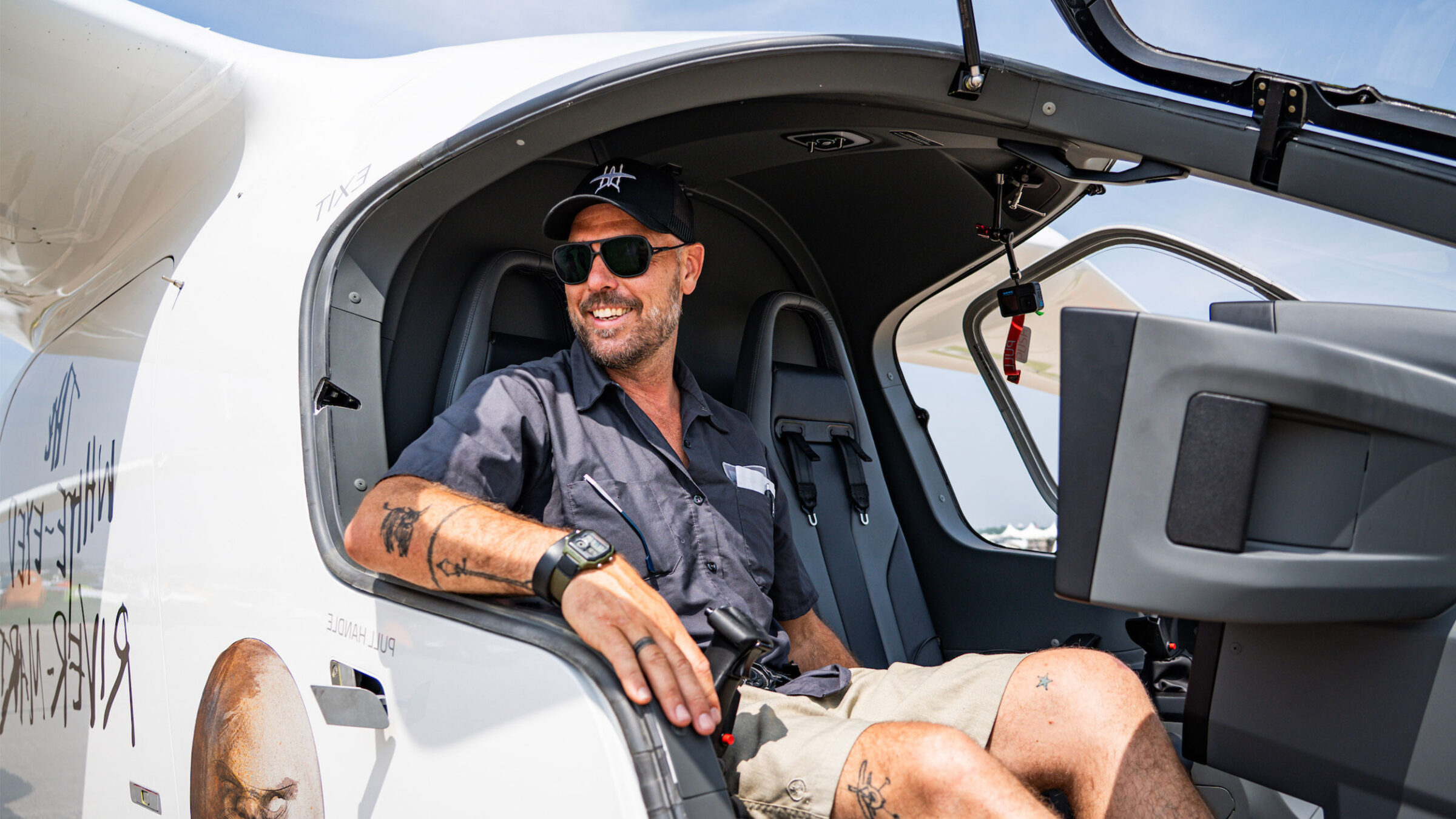 kyle clark sits in a beta aircraft smiling