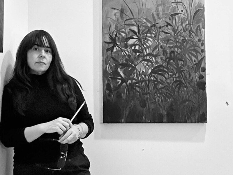 artist sage tucker-ketcham in front of her paintings