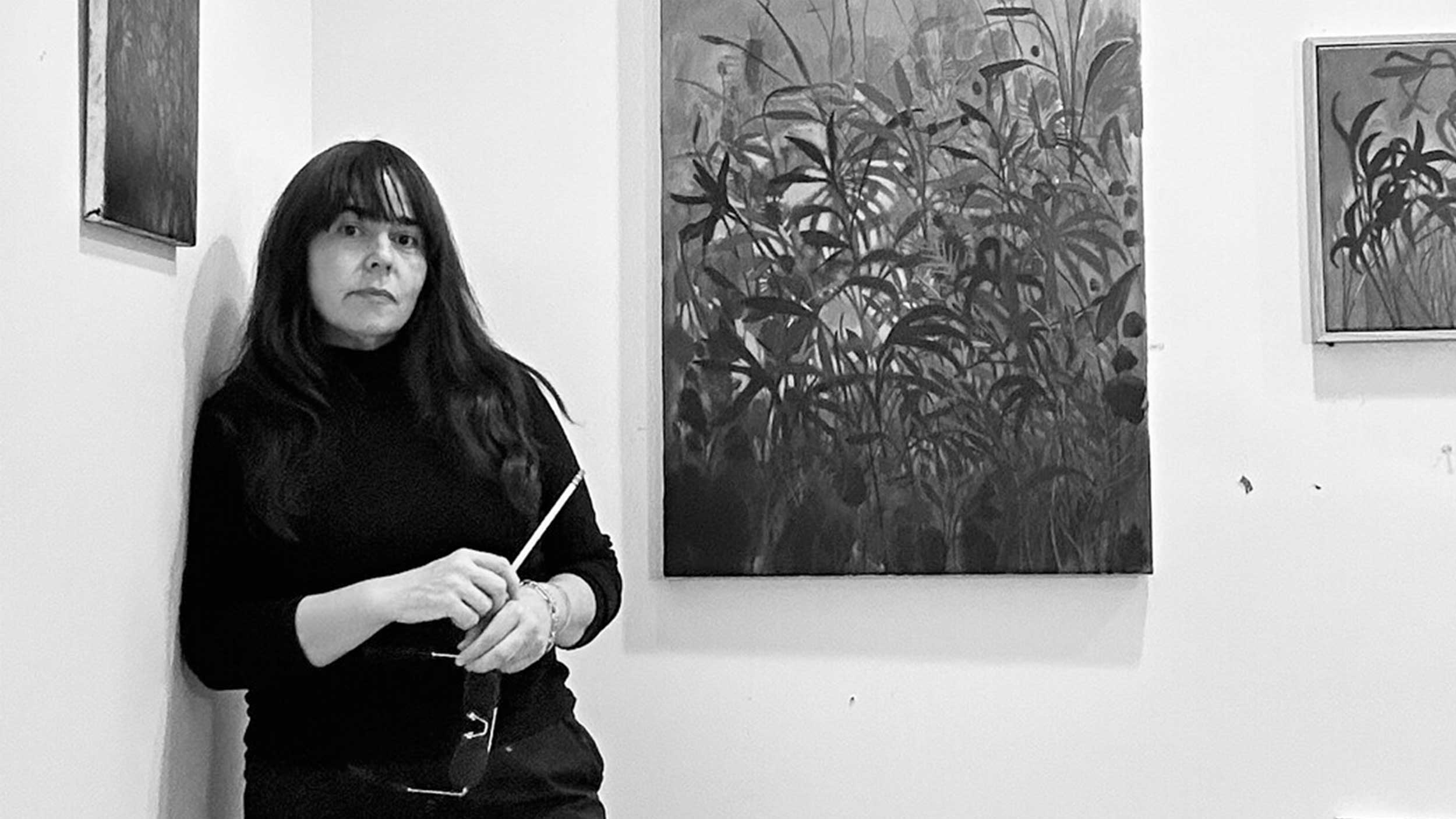 artist sage tucker-ketcham in front of her paintings