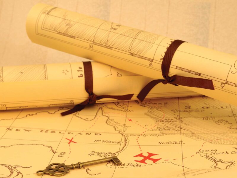 two map scrolls on a larger map with a key