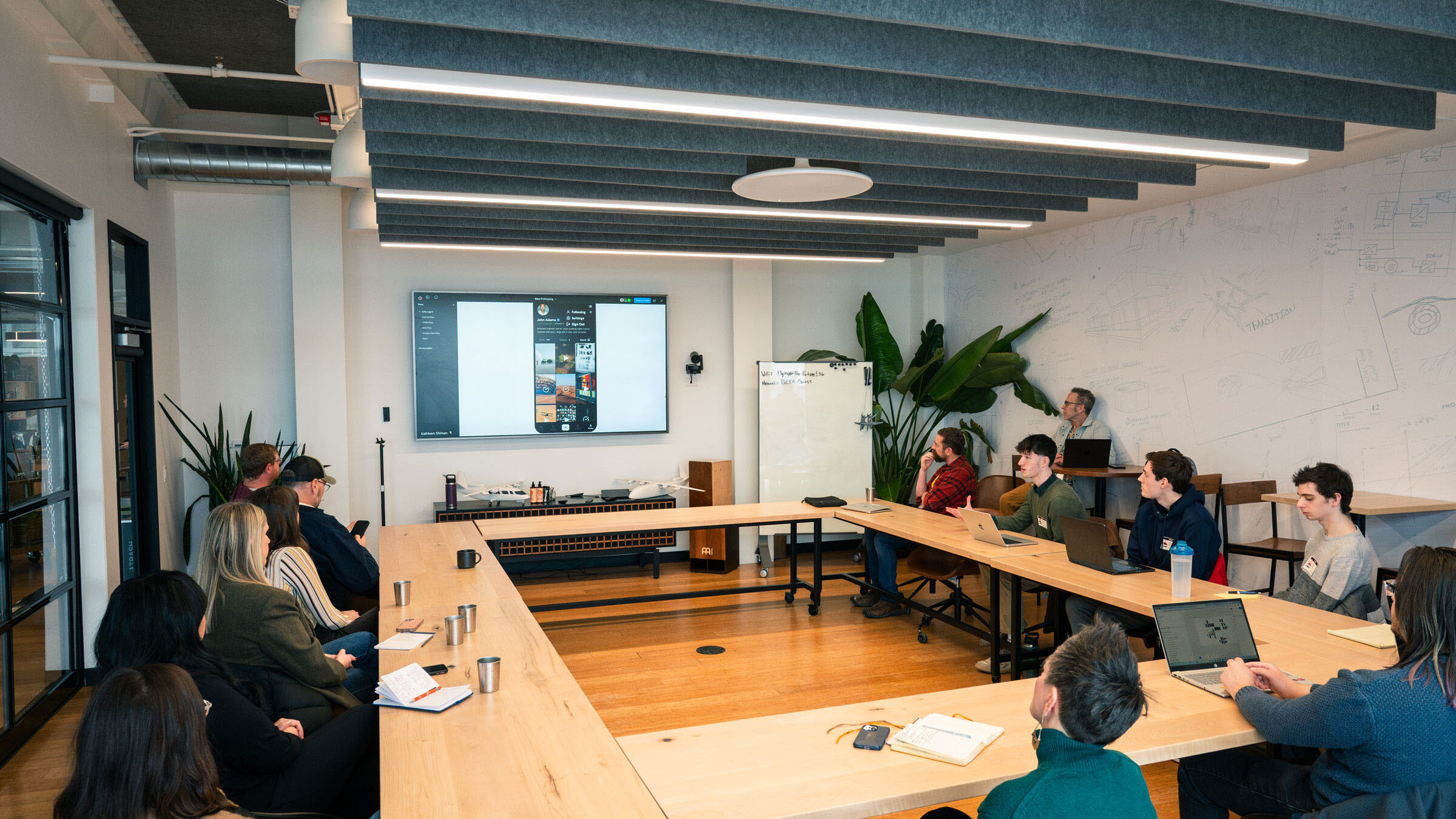 Students presenting at a conference with people around a large table