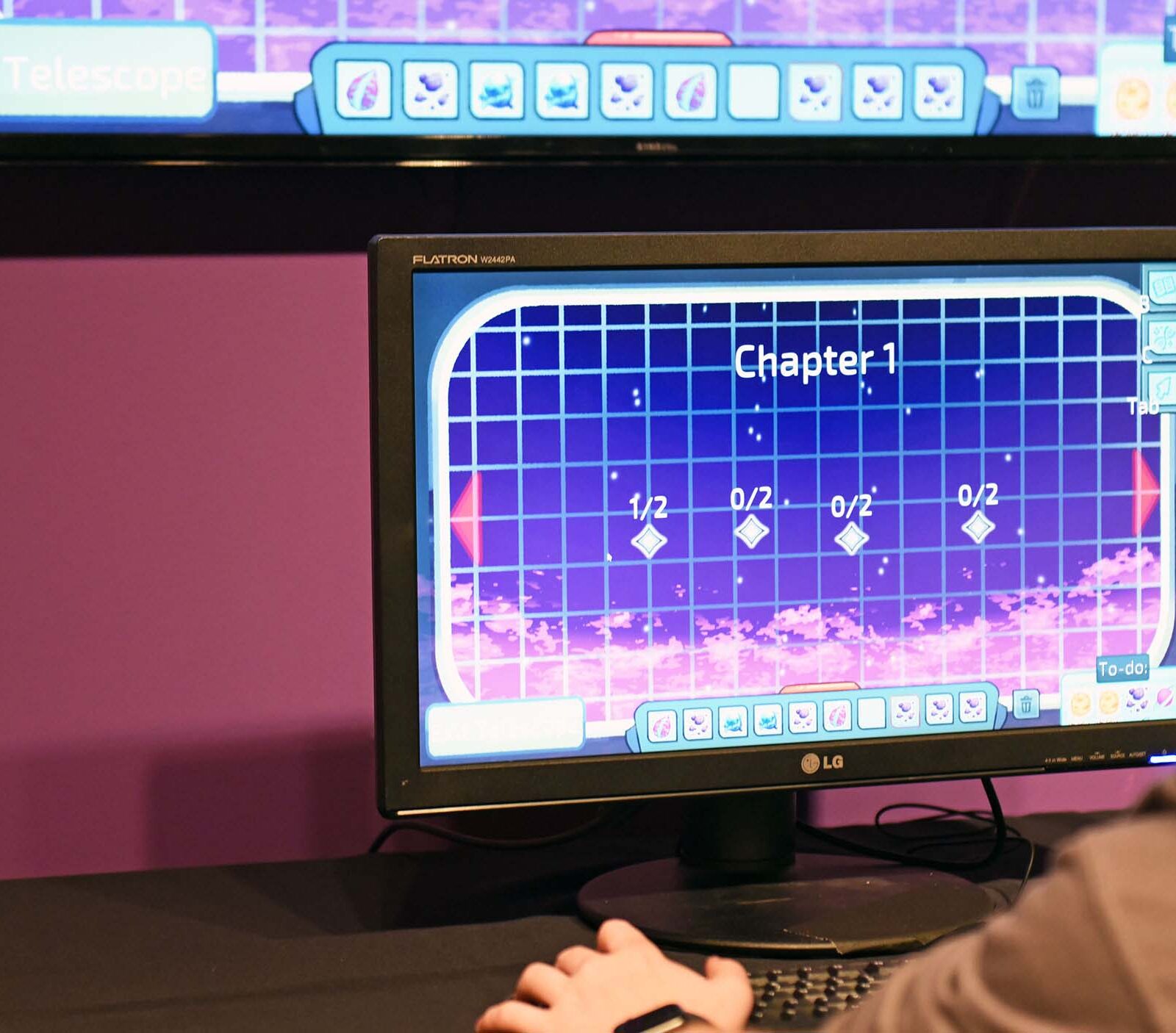 a student playing a game on a computer with purple lighting