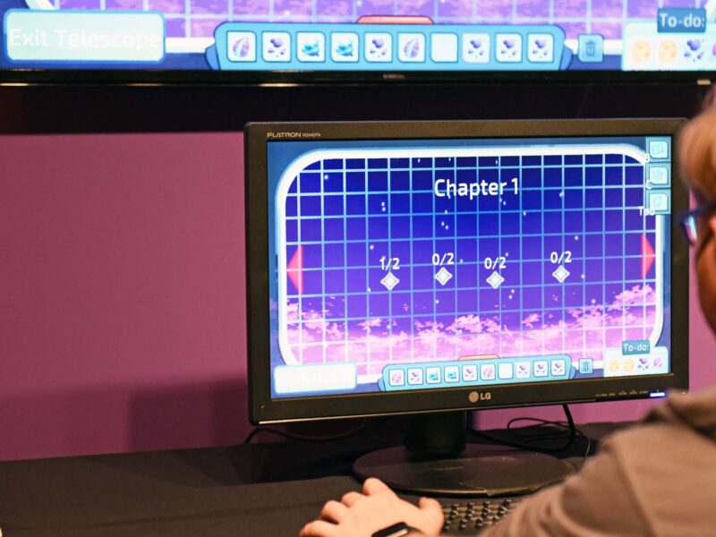 a student playing a game on a computer with purple lighting