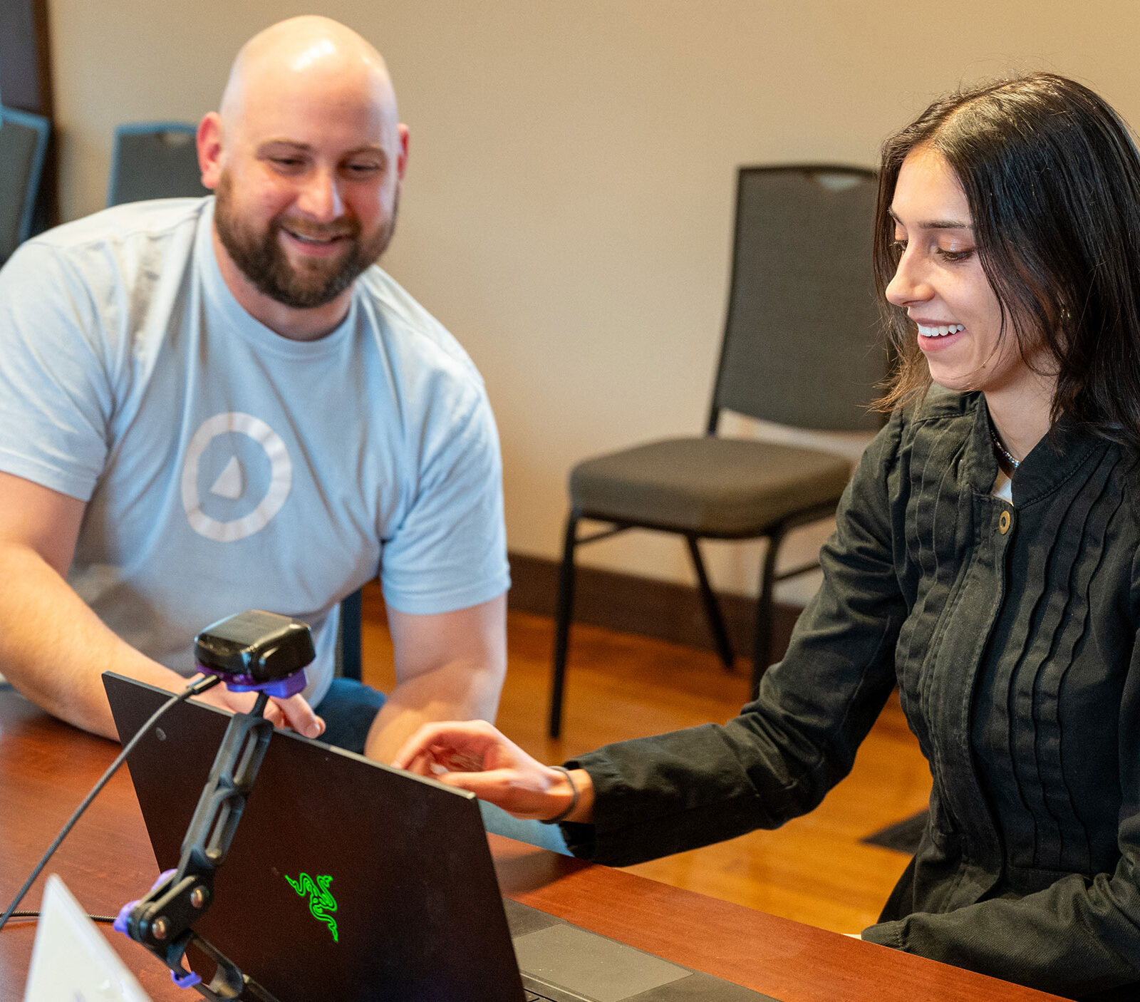 A staff member from OVR Technology walks Champlain College staff member through a demo of their new Omara device.