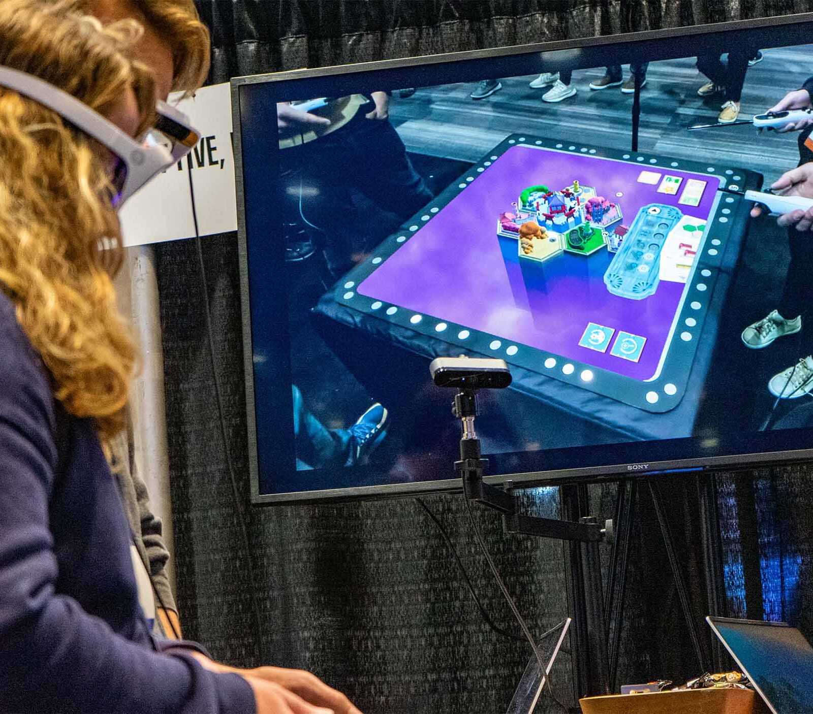 GDC attendees playtesting a game with headsets on