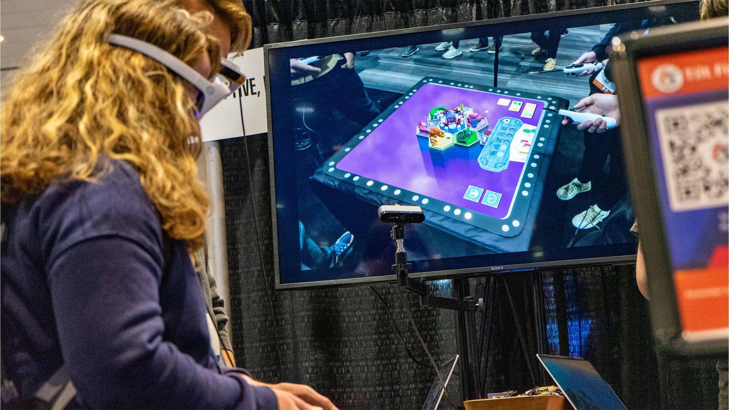 GDC attendees playtesting a game with headsets on