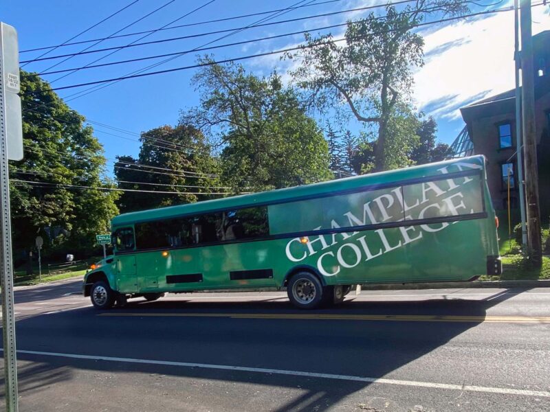 Green campus shuttle on the street