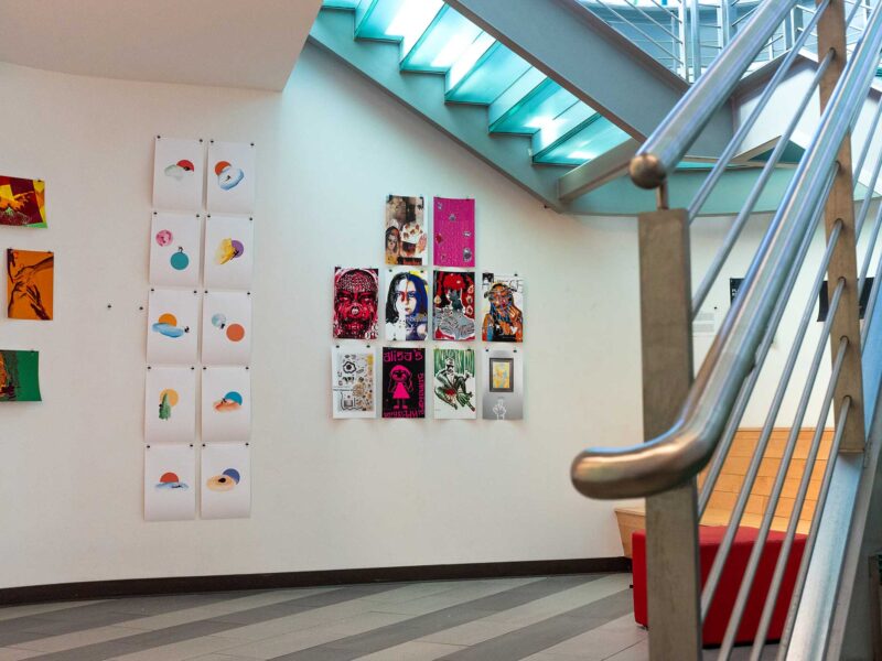 student-designed posters hanging in the stairnook gallery