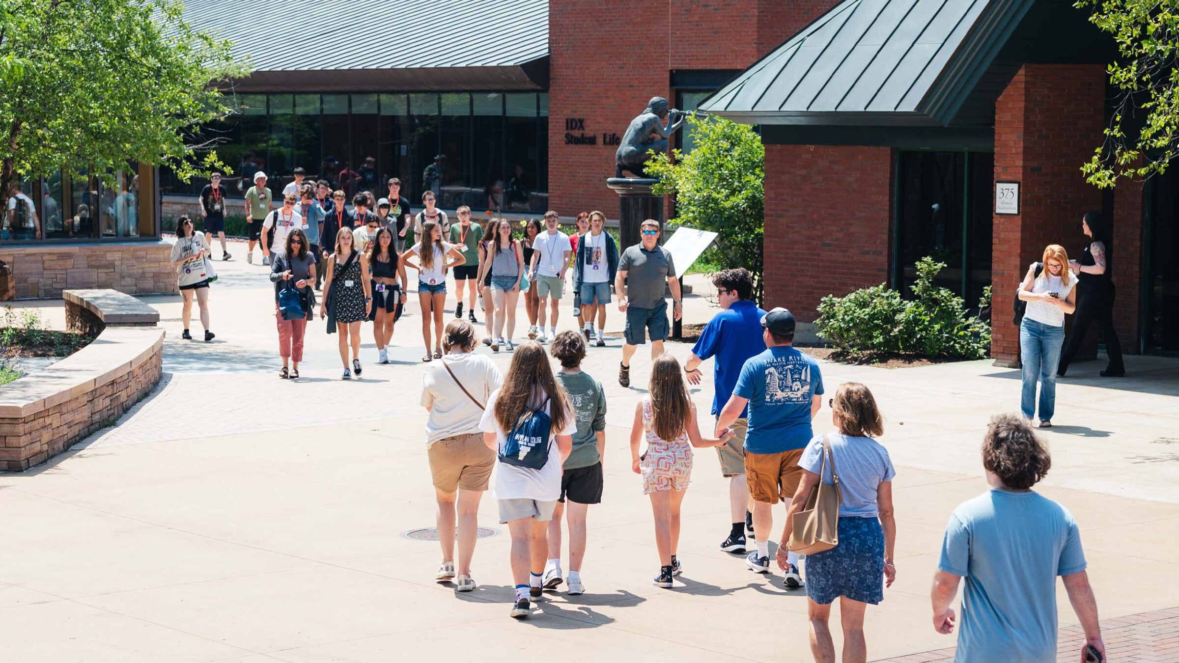 Prospective students and families visiting campus in the Summer, walking around near IDX in the courtyard