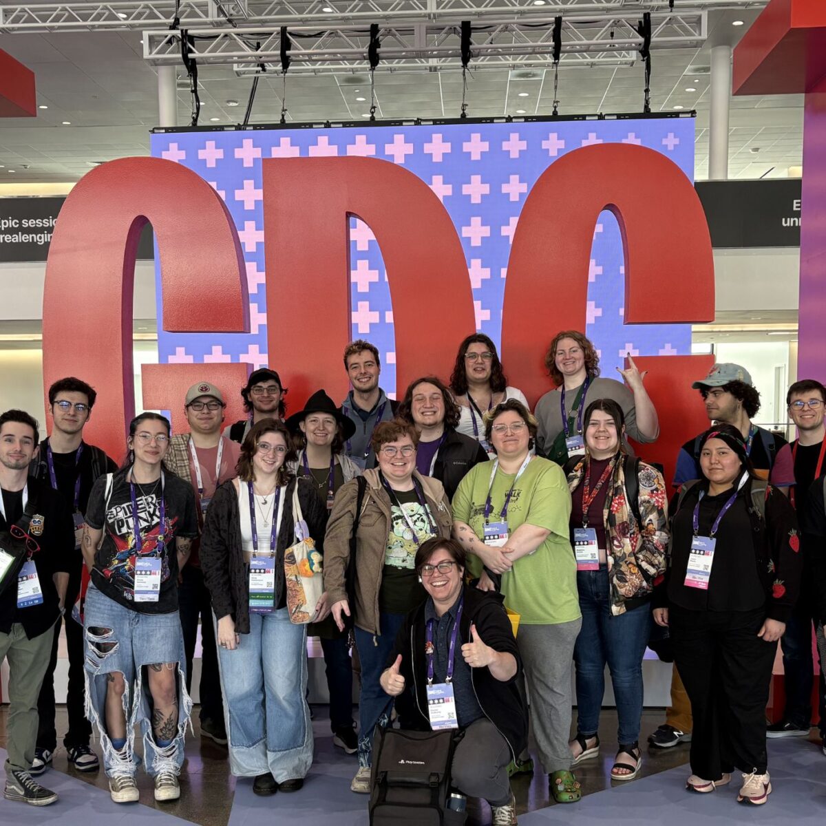 A group of Champlain College students stand in front of the Game Developer's Conference.