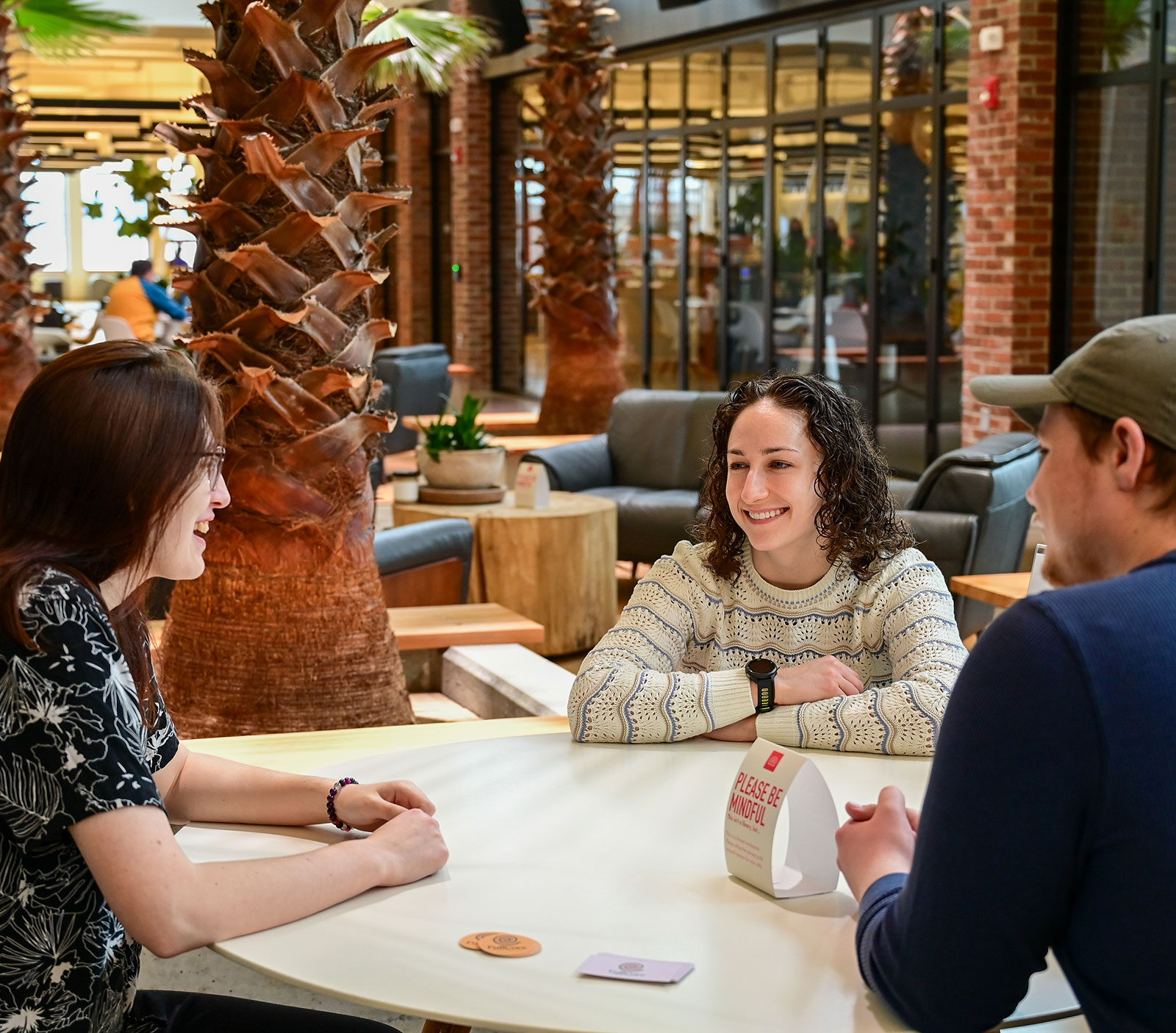 Two marketing students have a meeting with Azilee Curl at Hula.