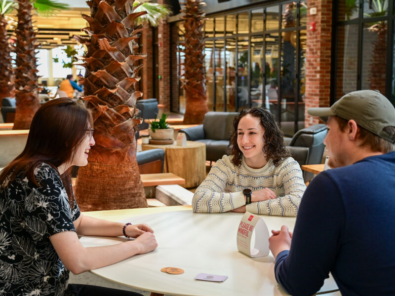 Two marketing students have a meeting with Azilee Curl at Hula.