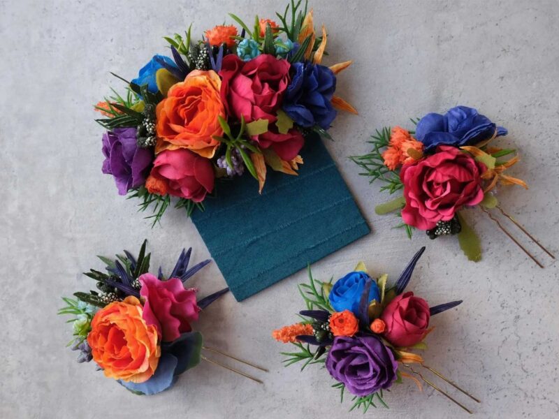 four lapel pins made with vibrant-colored flowers