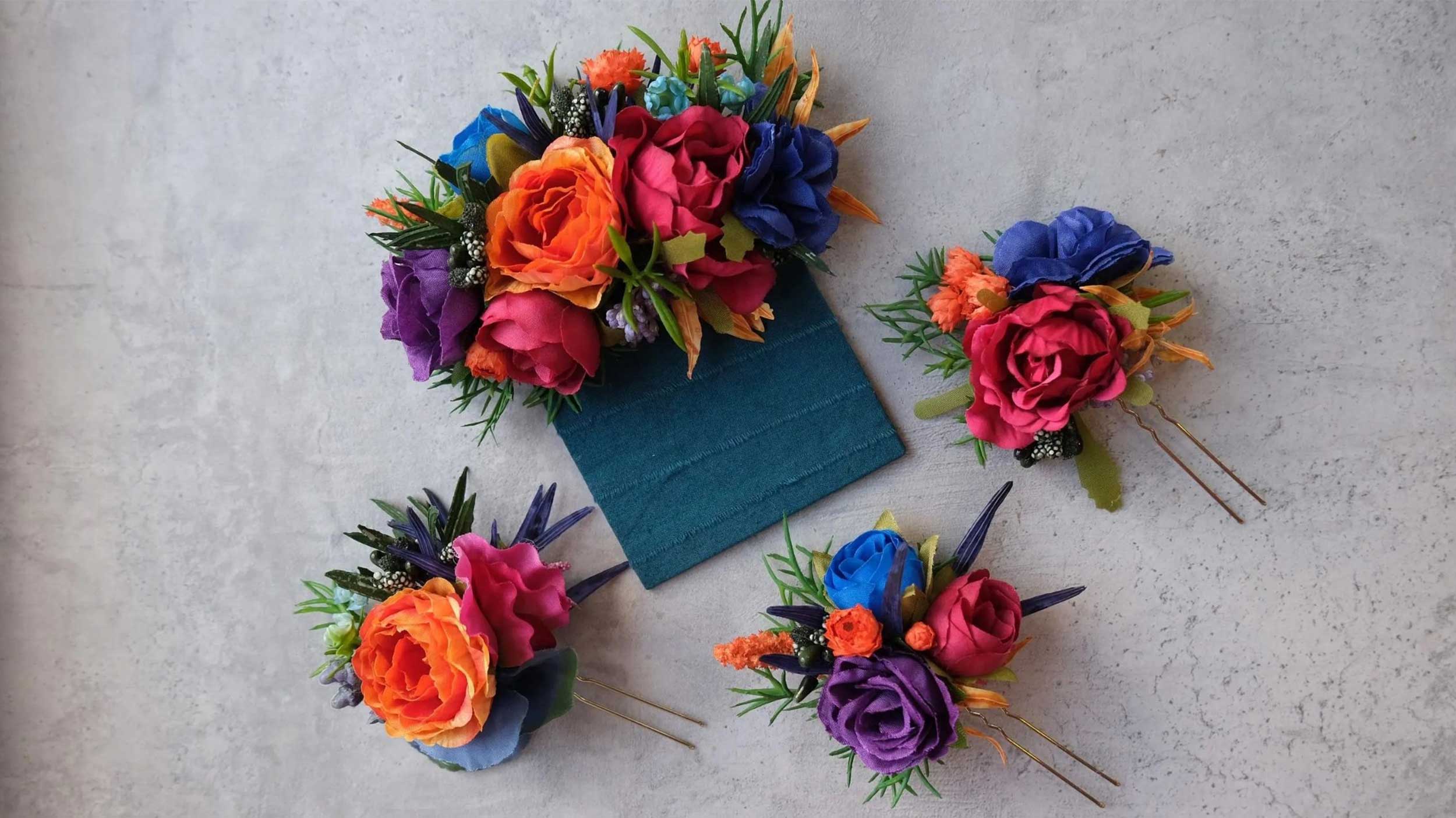 four lapel pins made with vibrant-colored flowers