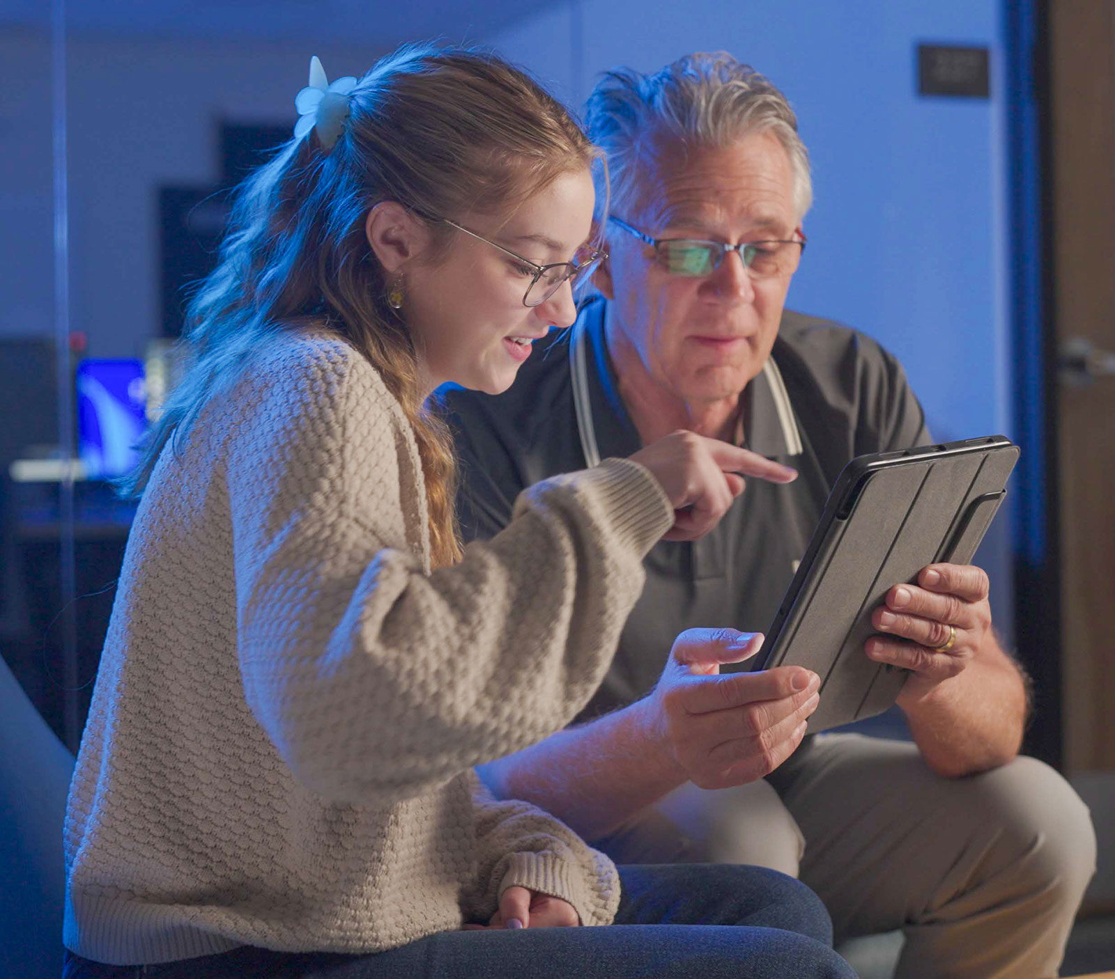 Student and faculty looking at iPad
