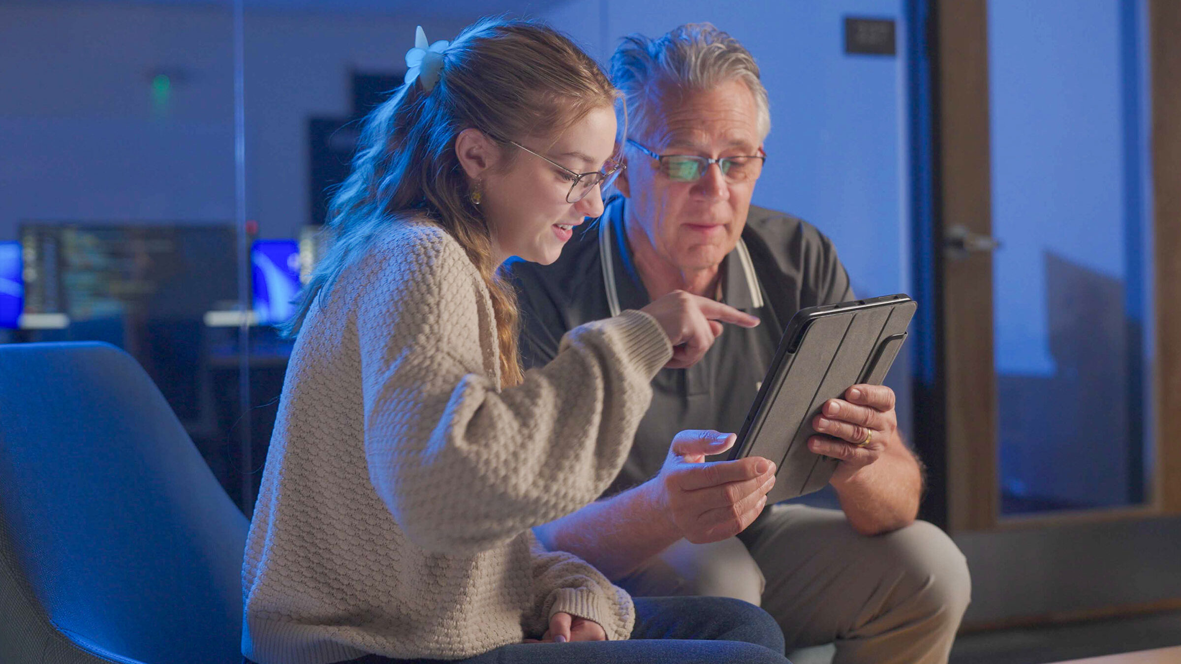 Student and faculty looking at iPad