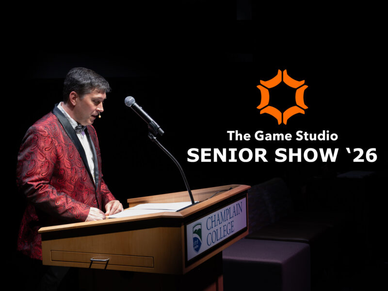 Presenter standing at the podium announcing the 2026 Game Senior Show against a black background and the game studio logo