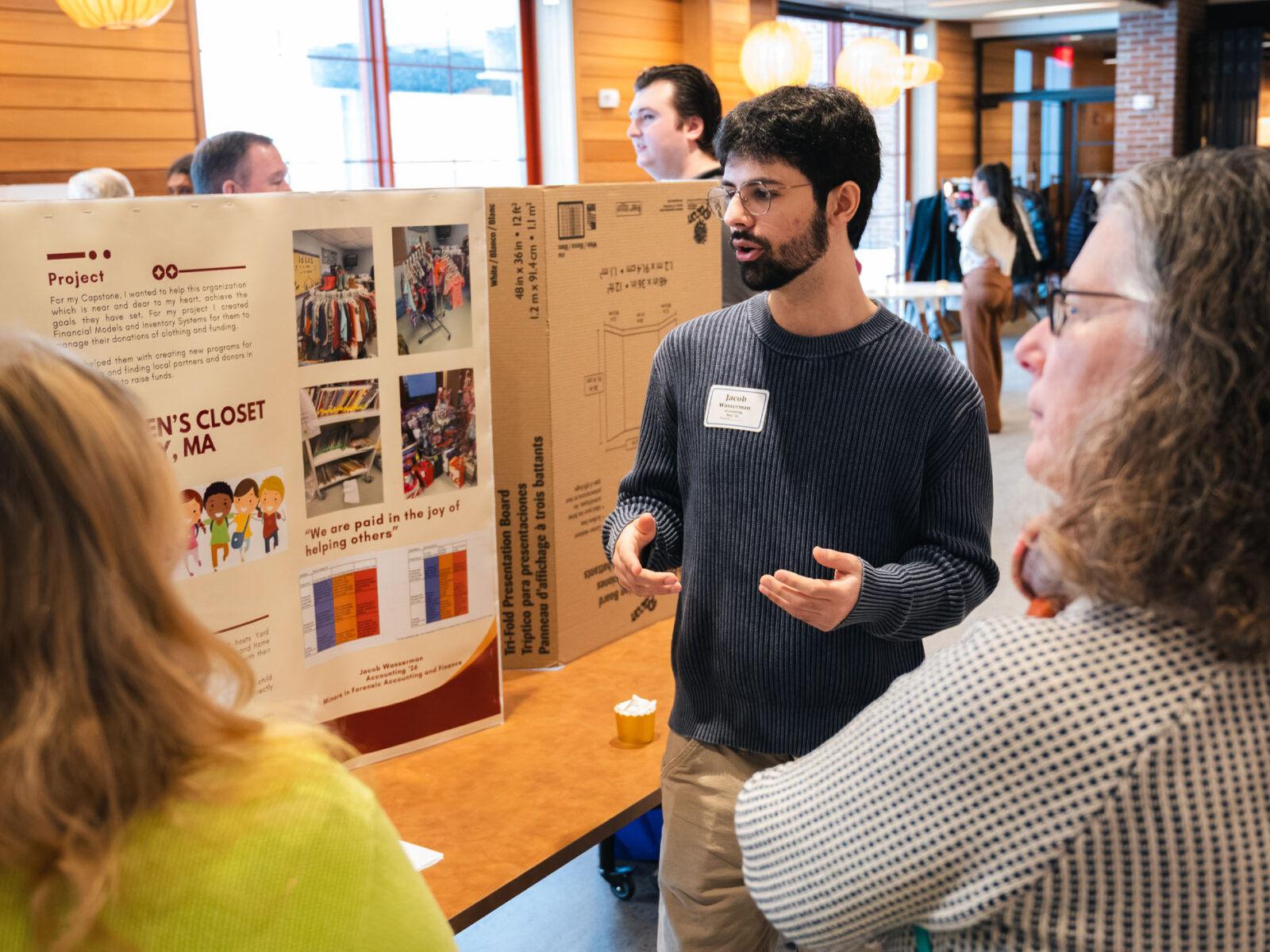 Student presenting their capstone to faculty and staff on Non-profits in the Hula lounge