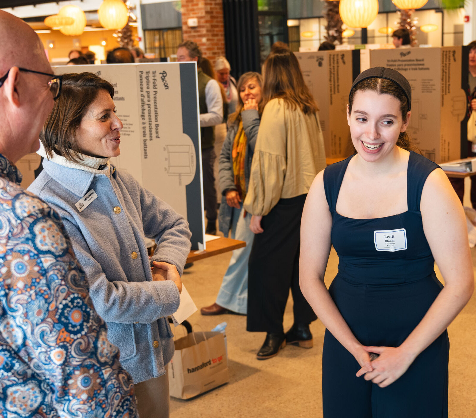 Student presenting their capstone to professors and staff at Hula during the business capstone showcase