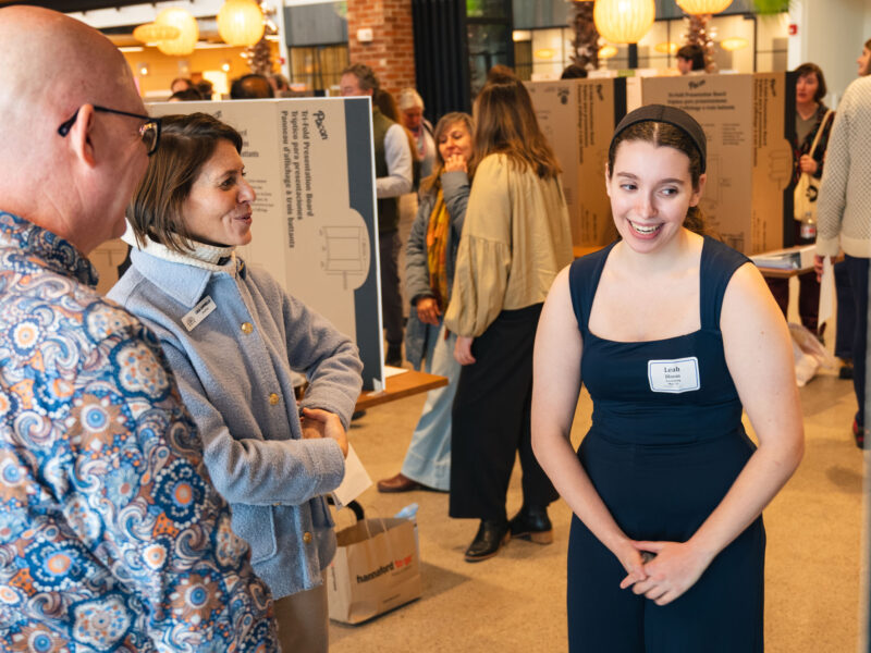 Student presenting their capstone to professors and staff at Hula during the business capstone showcase
