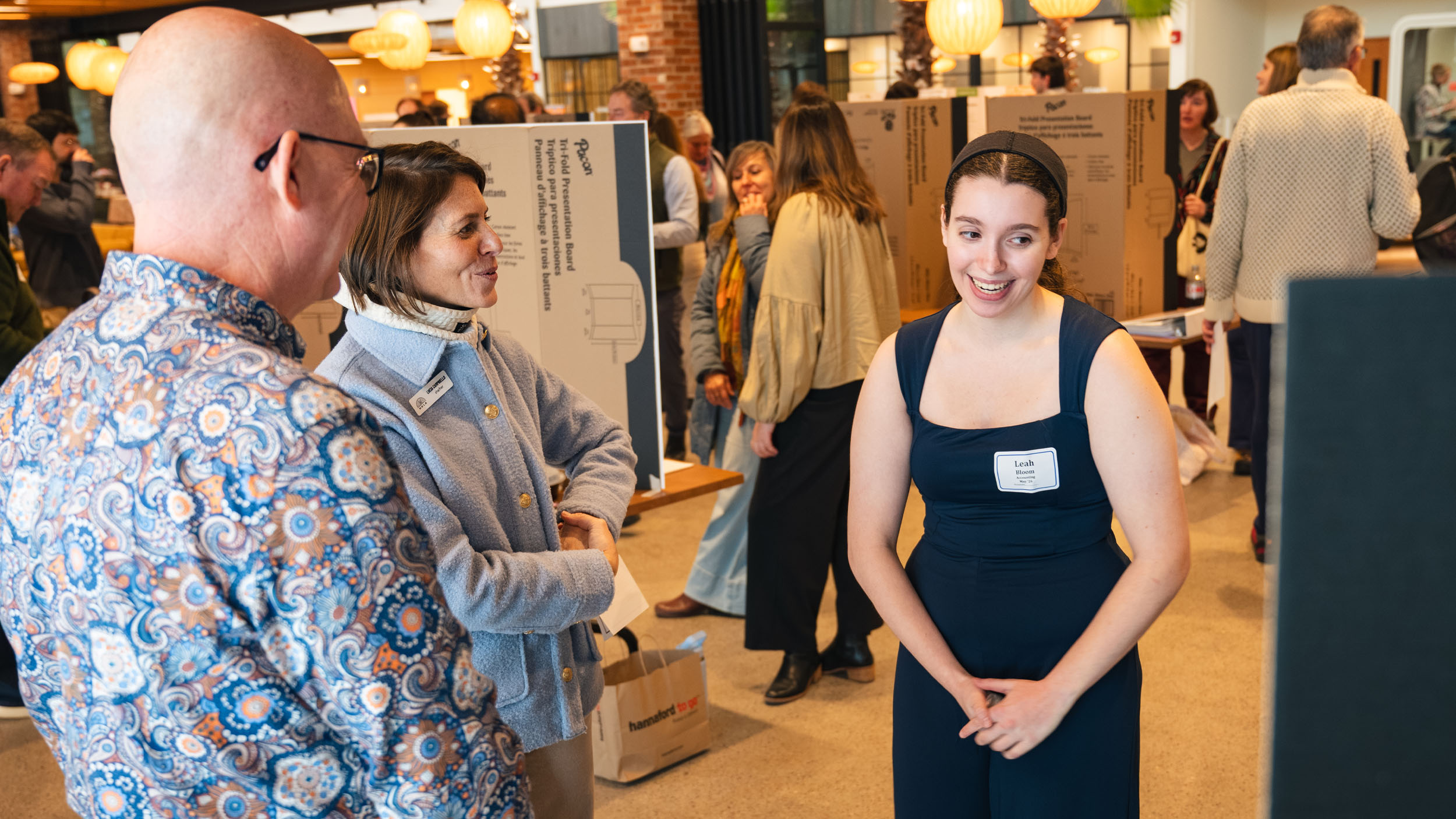 Student presenting their capstone to professors and staff at Hula during the business capstone showcase