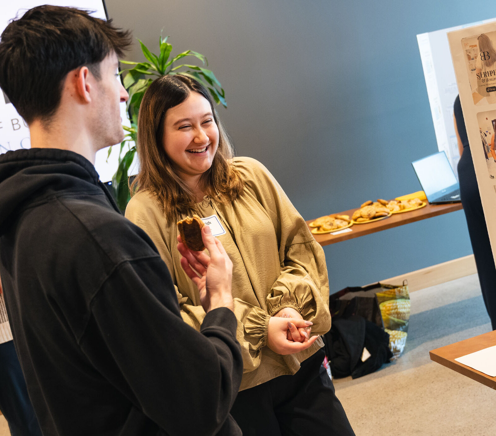 Two students talking during a capstone presentation in Hula